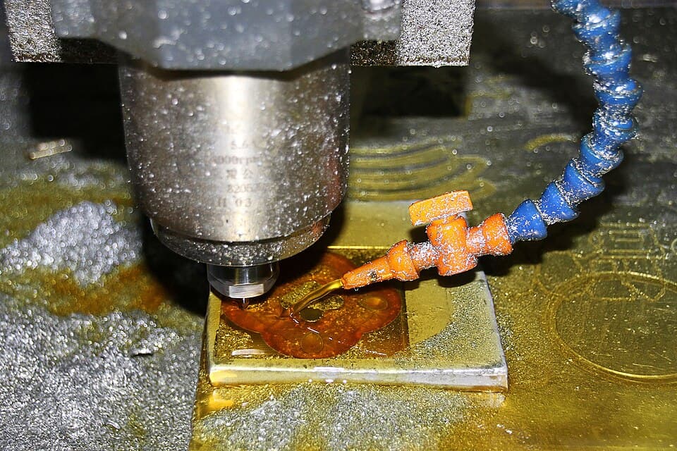CNC milling machine cutting a precision metal component