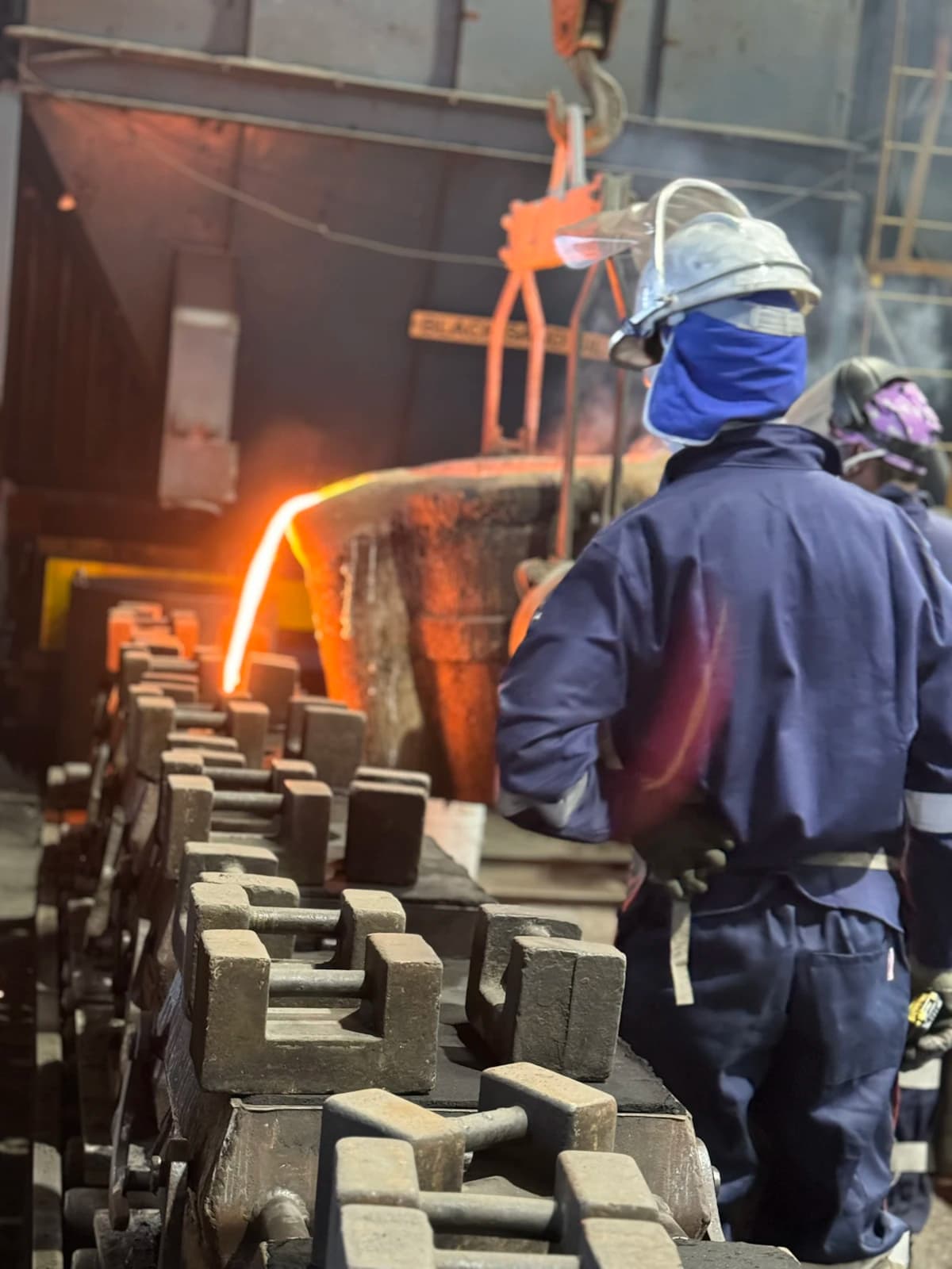 Molten metal being poured at an industrial foundry
